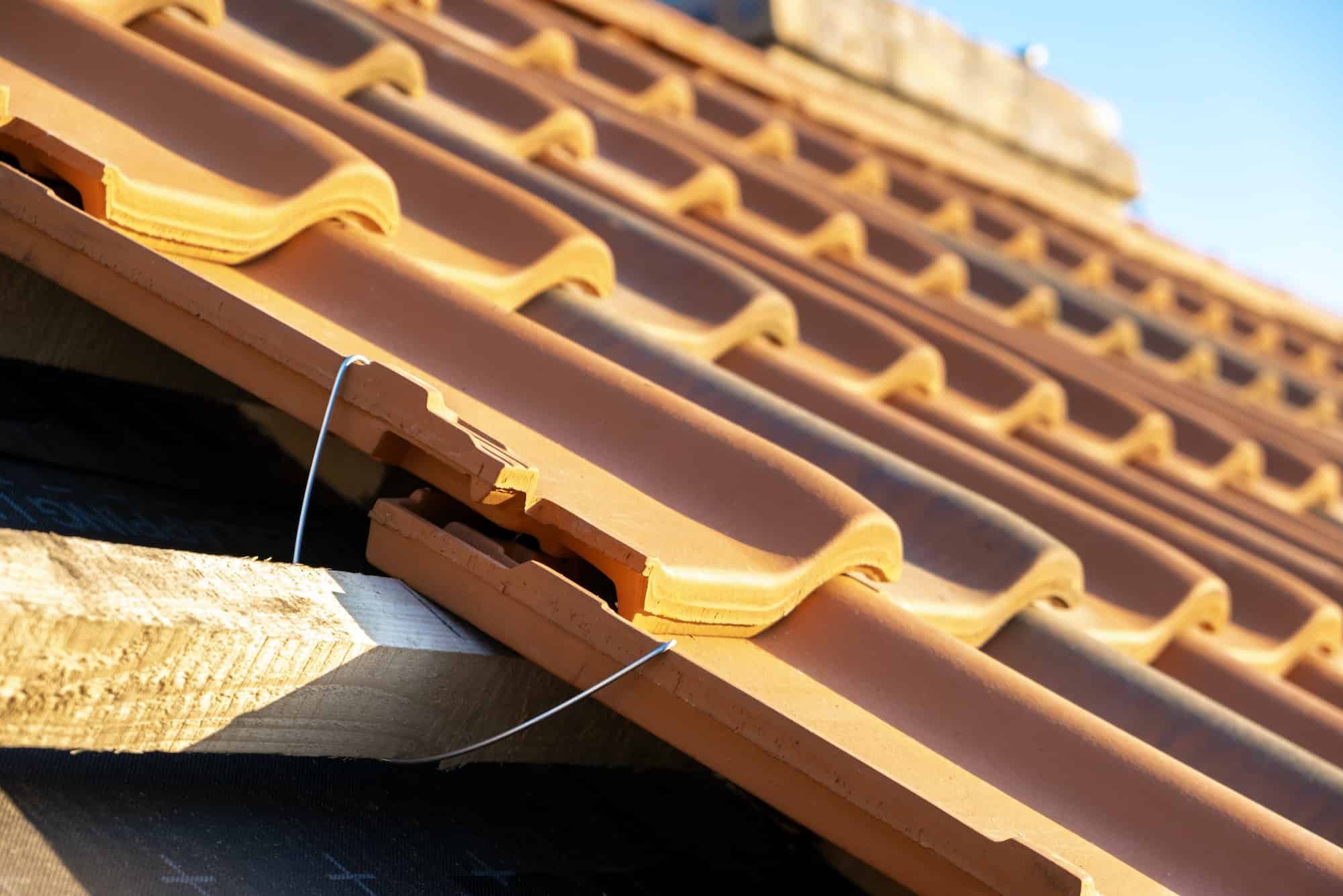 Technician cleaning gutters on a Melbourne home